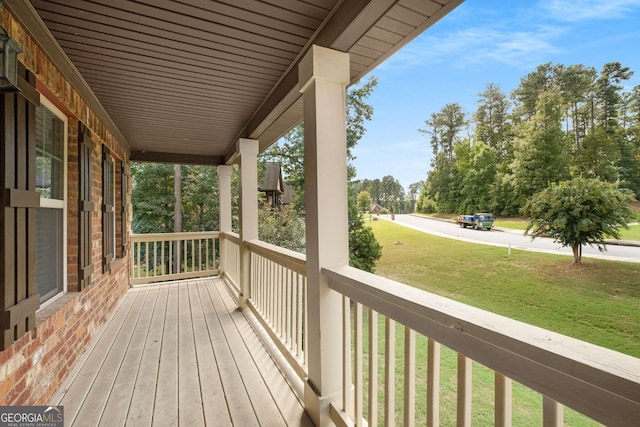 deck with a lawn and a porch