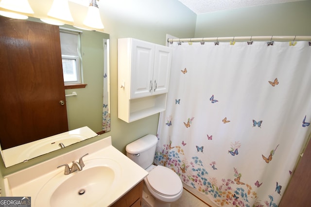 bathroom featuring vanity, curtained shower, and toilet