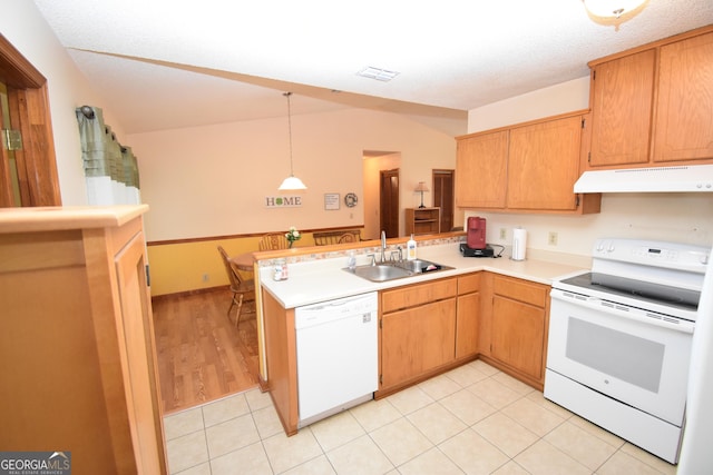 kitchen with under cabinet range hood, light countertops, a peninsula, white appliances, and a sink