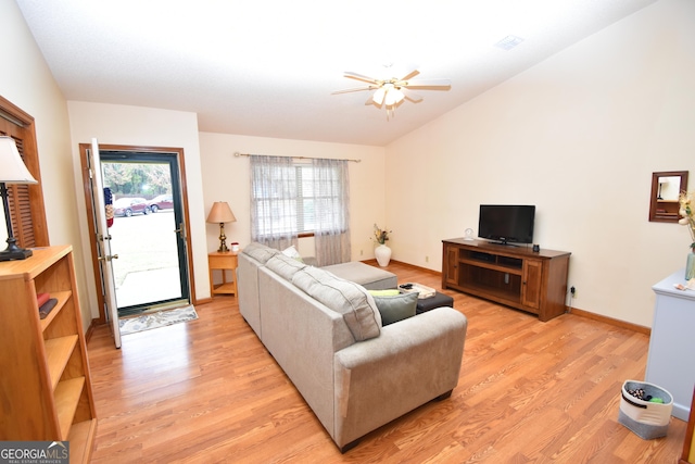 living room featuring visible vents, light wood-style flooring, a ceiling fan, baseboards, and vaulted ceiling