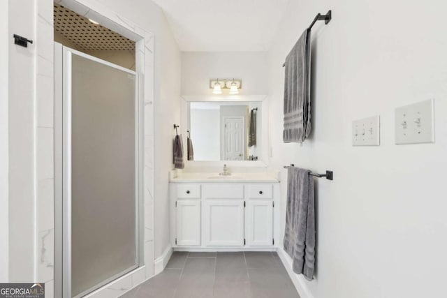 full bathroom with tile patterned floors, baseboards, a stall shower, and vanity