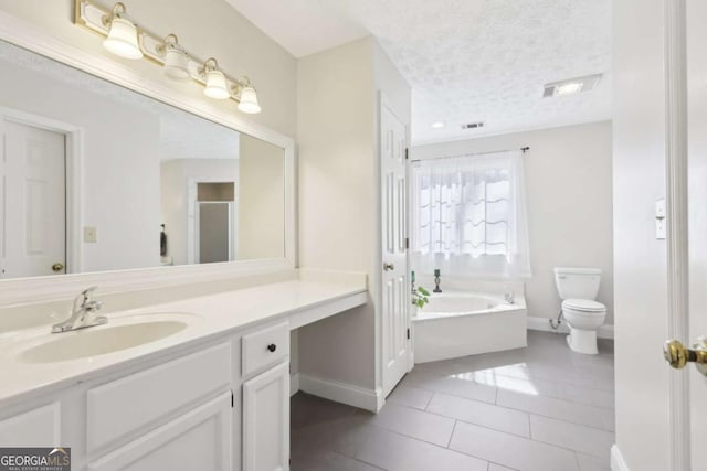 full bath with vanity, a bath, a textured ceiling, tile patterned floors, and toilet