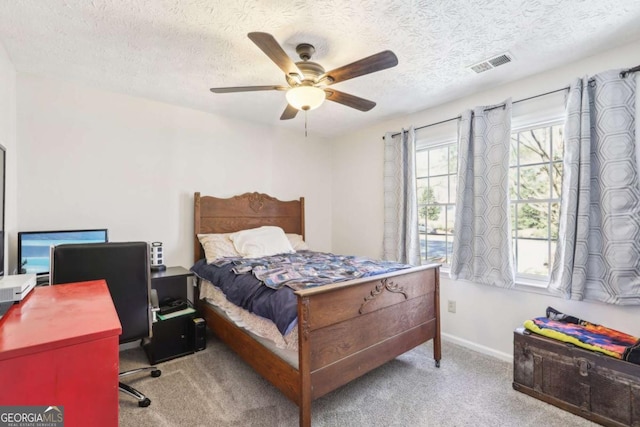 bedroom with baseboards, visible vents, ceiling fan, a textured ceiling, and carpet flooring