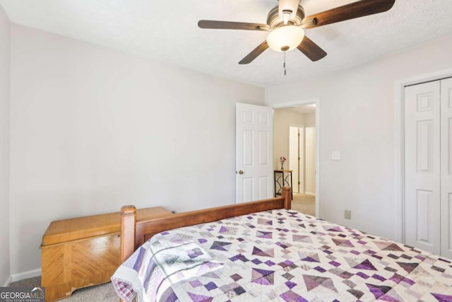 carpeted bedroom featuring a closet and ceiling fan