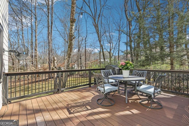 wooden terrace with outdoor dining area