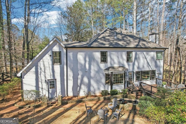 back of property with a chimney