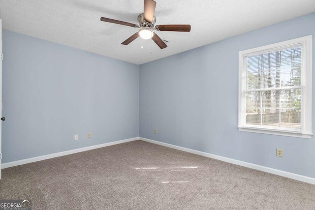 unfurnished room featuring a ceiling fan, baseboards, carpet floors, and a textured ceiling