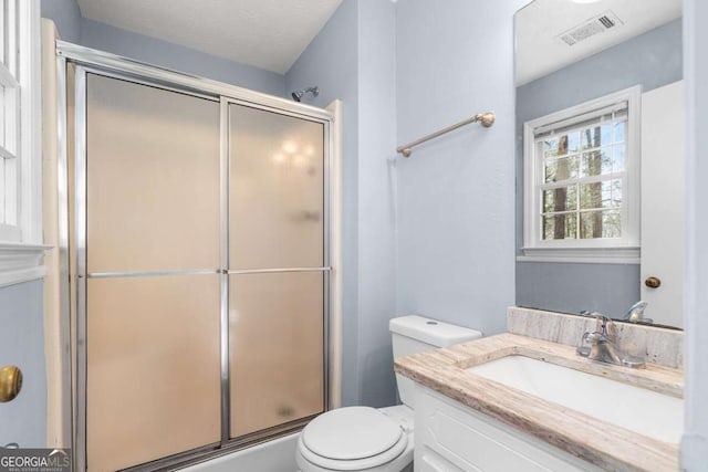 full bath featuring a shower with door, visible vents, toilet, and vanity