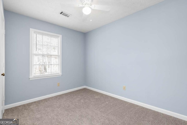 unfurnished room with visible vents, baseboards, and carpet floors