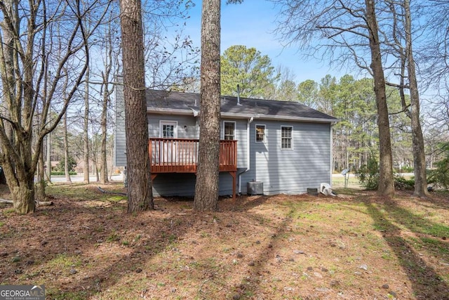 back of property featuring a deck and cooling unit