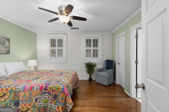 bedroom with visible vents, wood finished floors, baseboards, and ornamental molding