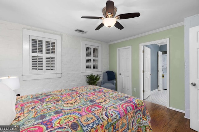 bedroom with visible vents, baseboards, ornamental molding, wood finished floors, and a ceiling fan