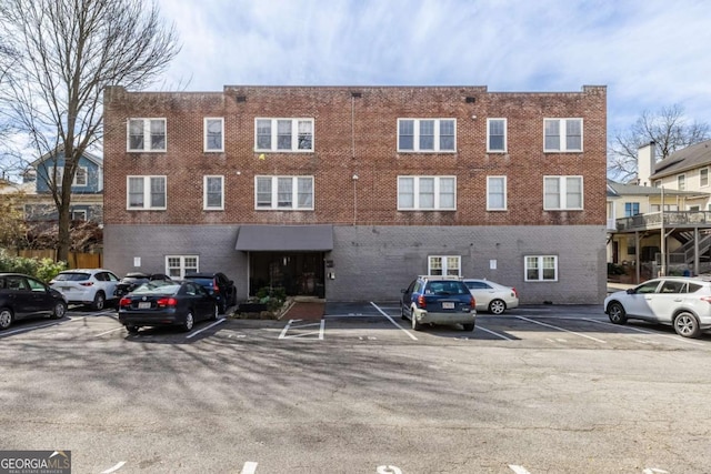 view of property featuring uncovered parking