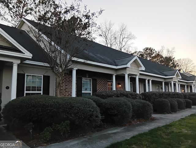 view of side of property featuring brick siding