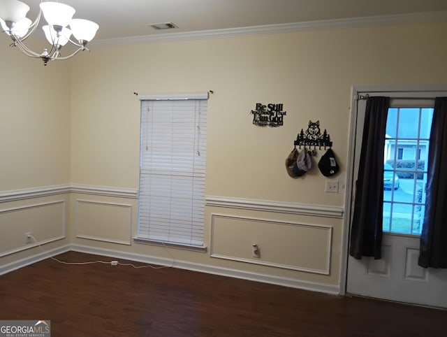 unfurnished dining area featuring visible vents, wainscoting, an inviting chandelier, and ornamental molding