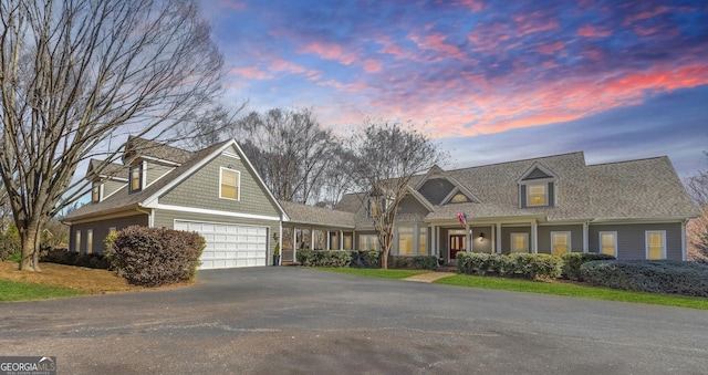 view of front of property with aphalt driveway and a shingled roof