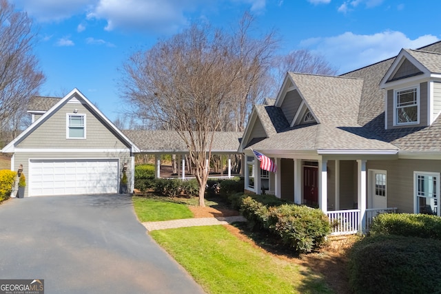 view of front of property with a garage, aphalt driveway, a porch, and a shingled roof