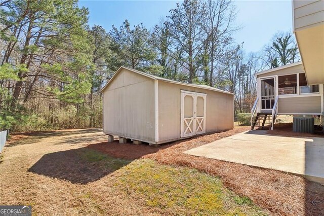 view of shed featuring central AC unit and a sunroom