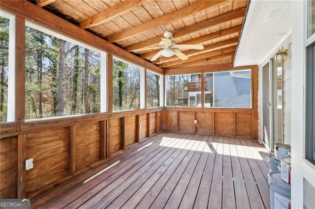 unfurnished sunroom with a sauna, beamed ceiling, wooden ceiling, and ceiling fan