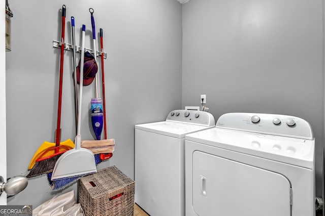 clothes washing area featuring washing machine and dryer and laundry area