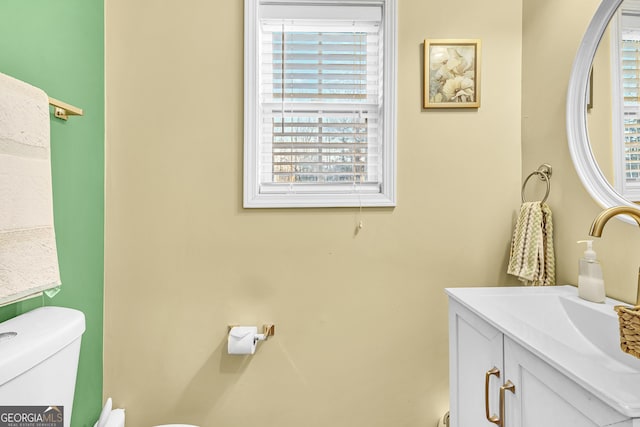 bathroom with toilet and vanity