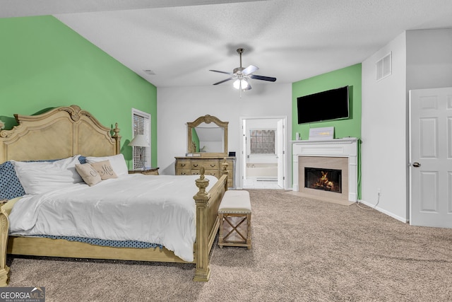 carpeted bedroom with a fireplace with flush hearth, baseboards, visible vents, and a textured ceiling