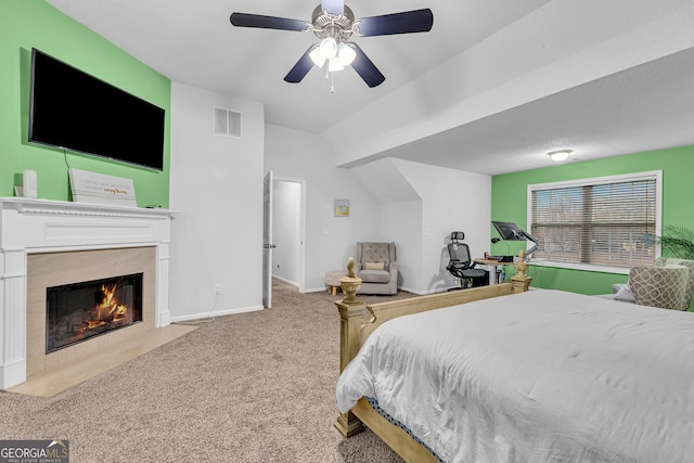 carpeted bedroom with visible vents, a fireplace, a ceiling fan, and baseboards