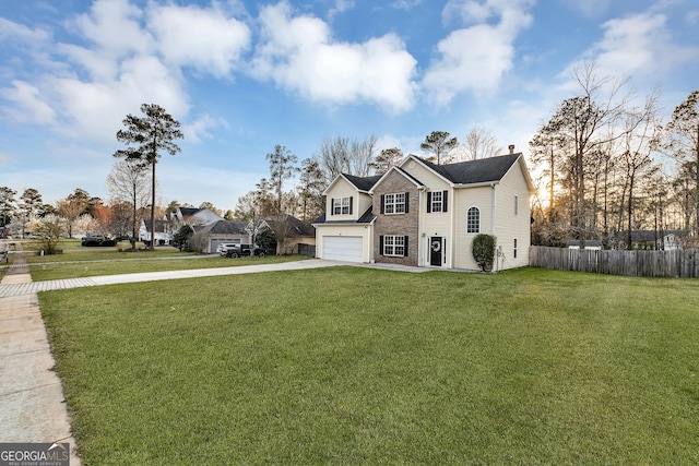 traditional-style home with fence, concrete driveway, a front yard, an attached garage, and a chimney