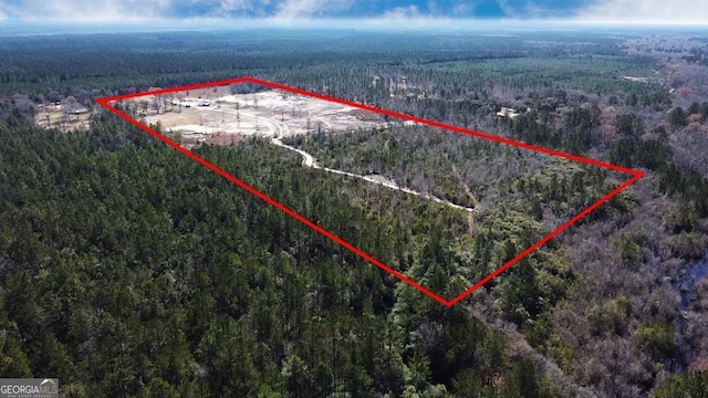 birds eye view of property with a view of trees