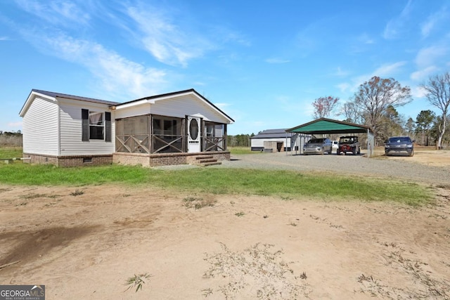 rear view of house with a carport and driveway