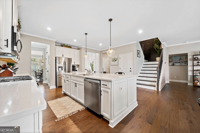 kitchen featuring a sink, stainless steel appliances, dark wood-type flooring, and white cabinetry