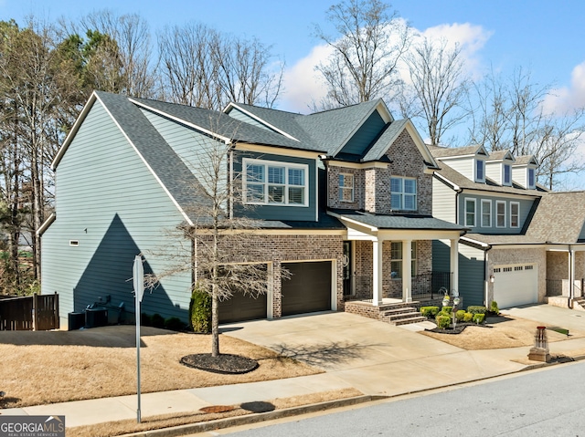 view of front of house with a garage, brick siding, roof with shingles, and concrete driveway