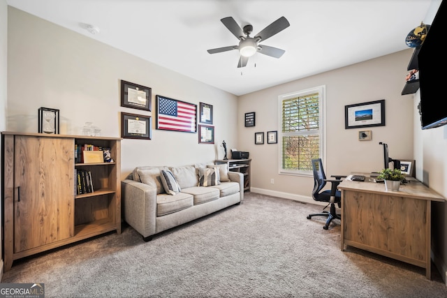 carpeted office featuring ceiling fan and baseboards