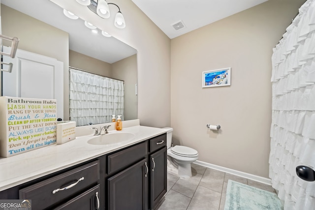 full bath featuring vanity, baseboards, visible vents, tile patterned floors, and toilet