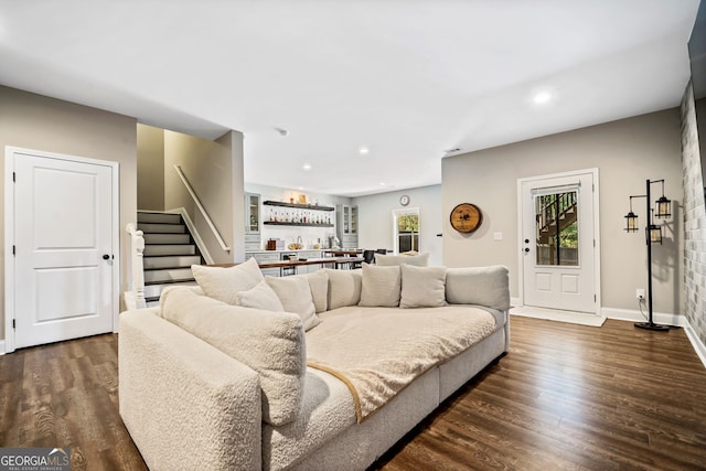 living room featuring stairway, recessed lighting, dark wood-style flooring, and baseboards