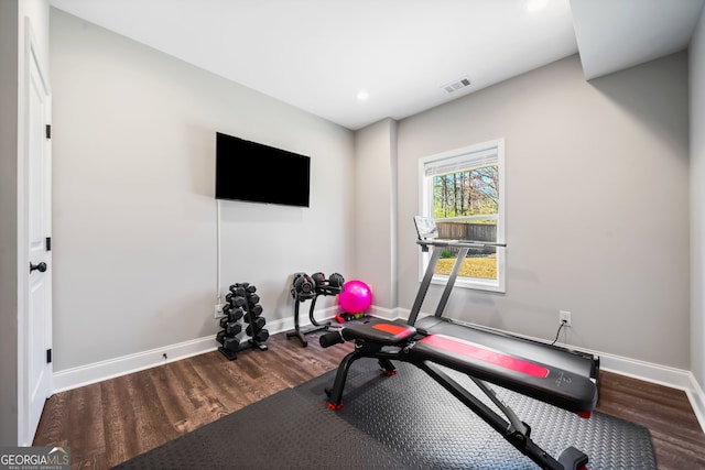 workout area with wood finished floors, baseboards, and visible vents