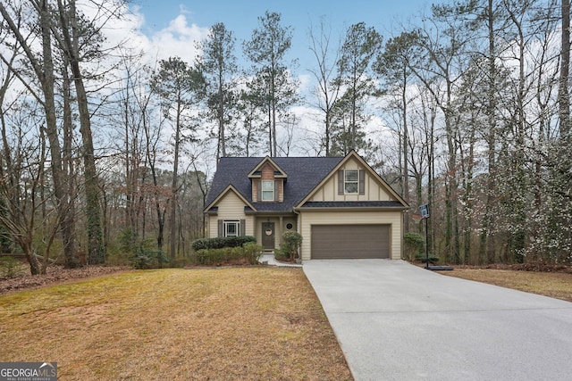 craftsman-style house with a garage, board and batten siding, concrete driveway, and a front yard