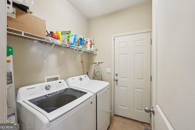 laundry area featuring washer and dryer, laundry area, and light tile patterned floors