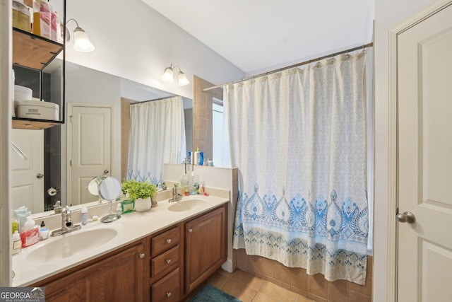 bathroom with a sink, curtained shower, double vanity, and tile patterned flooring