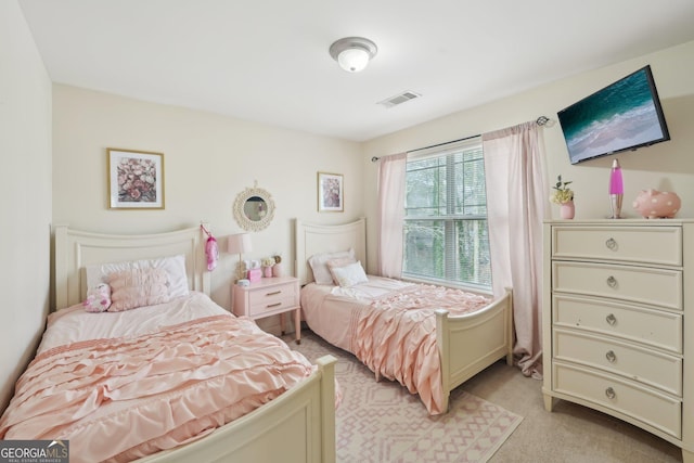 bedroom featuring visible vents and light carpet