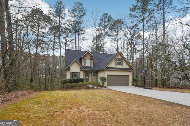 view of front facade with driveway, an attached garage, a front lawn, and board and batten siding