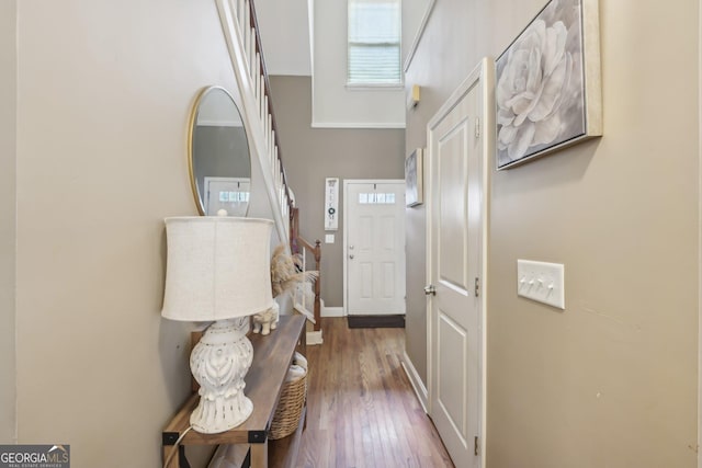 entrance foyer featuring baseboards and wood finished floors