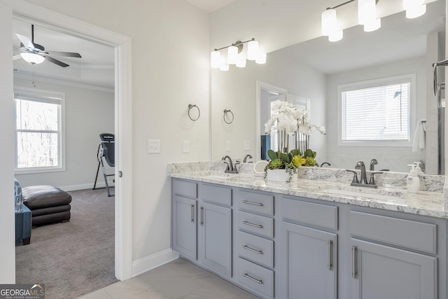 bathroom featuring a sink, marble finish floor, double vanity, and crown molding