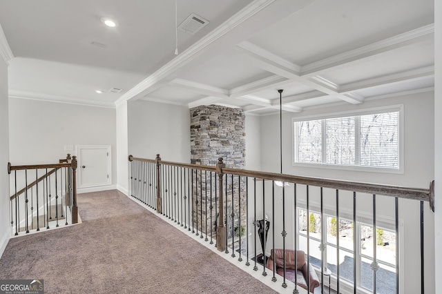 corridor with visible vents, crown molding, beamed ceiling, carpet flooring, and coffered ceiling