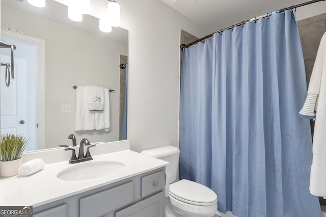 bathroom featuring vanity, toilet, a shower with curtain, and visible vents