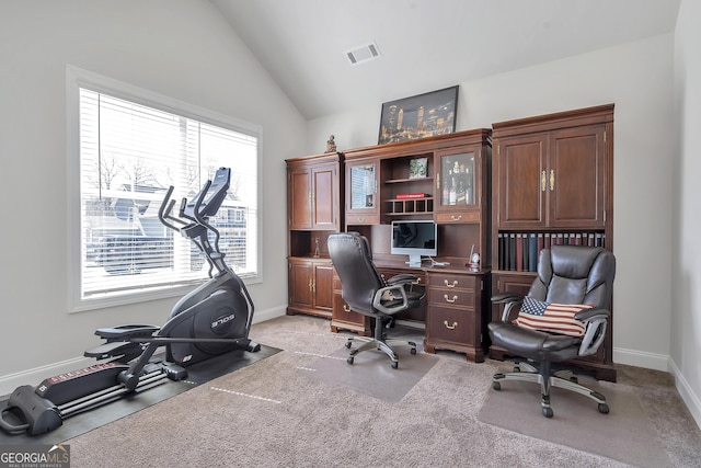 office space with lofted ceiling, baseboards, visible vents, and light carpet