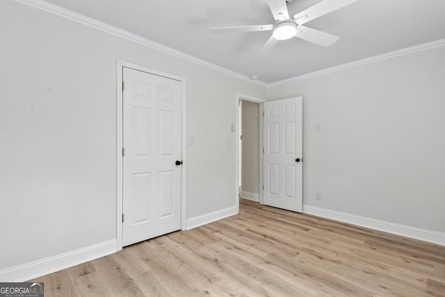 unfurnished bedroom with crown molding, baseboards, ceiling fan, and light wood-style flooring