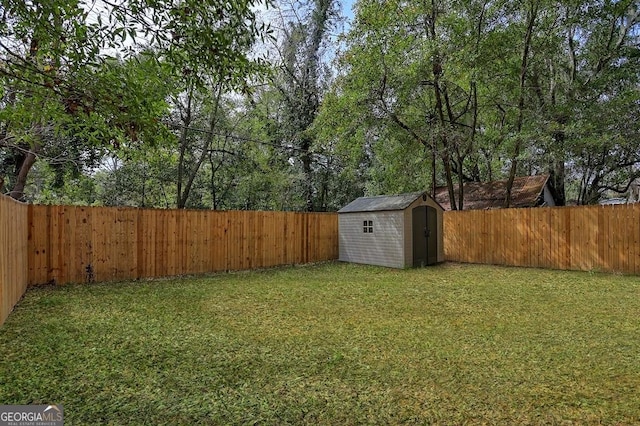 view of yard with a fenced backyard, an outdoor structure, and a shed
