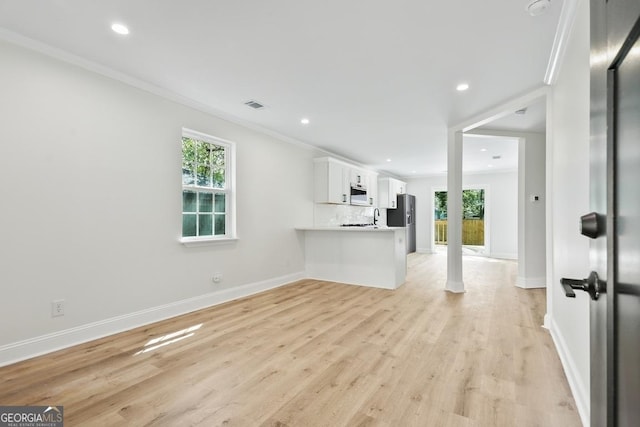 unfurnished living room featuring visible vents, crown molding, baseboards, recessed lighting, and light wood-style flooring