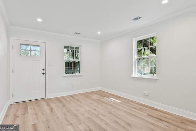 foyer with visible vents, baseboards, light wood-type flooring, ornamental molding, and recessed lighting